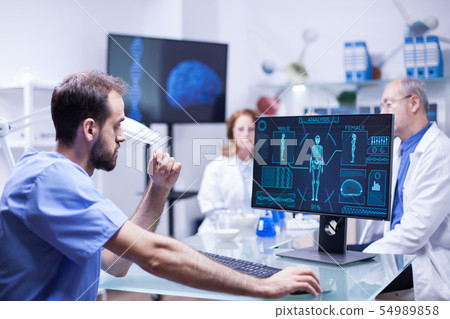 Portrait of young scientist looking at monitor computer checking male body 54989858
