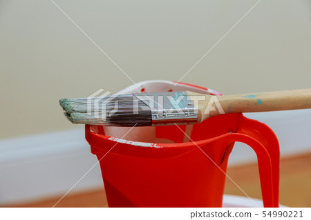 Paint brush on the can. Top view. renovation tool 54990221