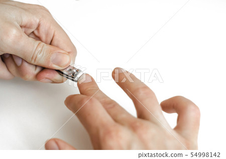 A young man does a manicure. Photo. 54998142