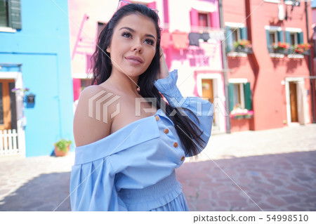 tourist woman posing among colorful houses on tourist woman posing among colorful houses on 54998510