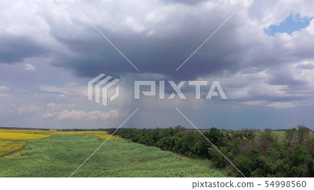 Farm fields against a cloudy sky. You can see how 54998560