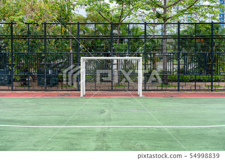 Soccer goal with net in rubber field 54998839