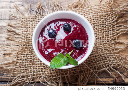 Blueberry jam in a plate and fresh blueberries Blueberry jam in a plate and fresh blueberries 54999033