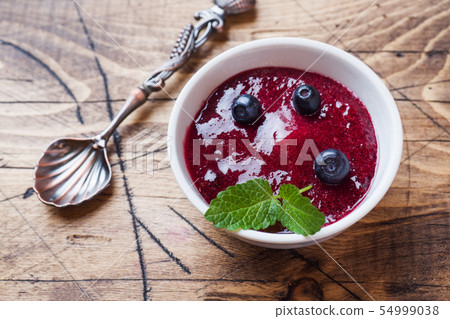 Blueberry jam in a plate and fresh blueberries Blueberry jam in a plate and fresh blueberries 54999038