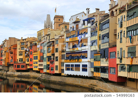 Colorful old houses on river Onyar in Girona 54999163