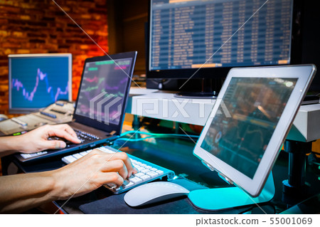Businessman trading stocks with multiple computers 55001069