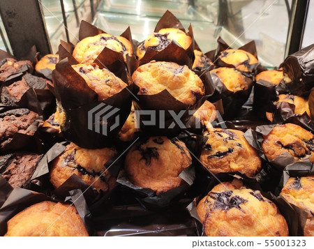 Various types of muffins are displayed for sale. Various types of muffins are displayed for sale. 55001323