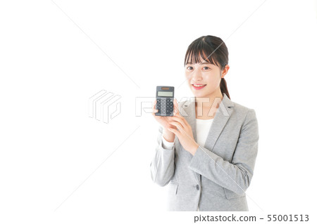 Young career woman doing calculations with a calculator 55001513
