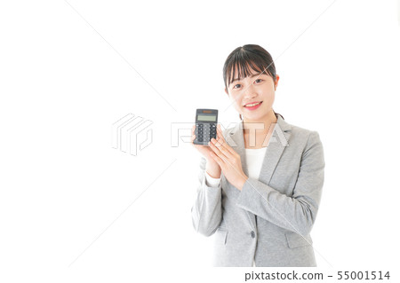 Young career woman doing calculations with a calculator Young career woman doing calculations with a calculator 55001514