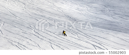Skier downhill on off-piste snowy ski slope Skier downhill on off-piste snowy ski slope 55002903