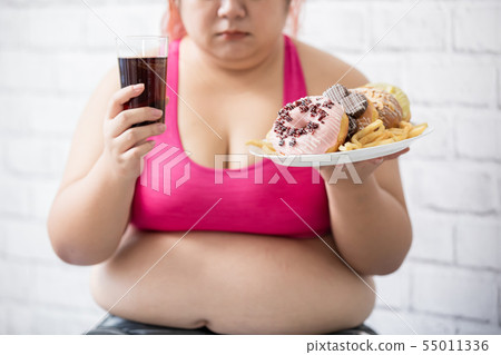 plus size girl with dessert 55011336