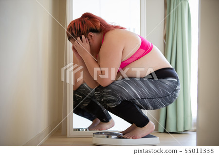 plus size woman feel upset 55011338