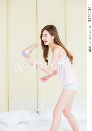 asian woman use hair dryer 55011504
