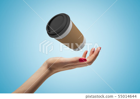 Female hand with coffee paper cup on blue background Female hand with coffee paper cup on blue background 55014644