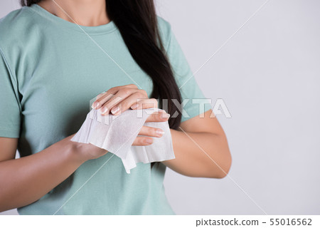 Woman cleaning her hands with a tissue. Healthcare 55016562