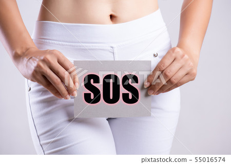 Closeup young woman holding paper with word SOS 55016574