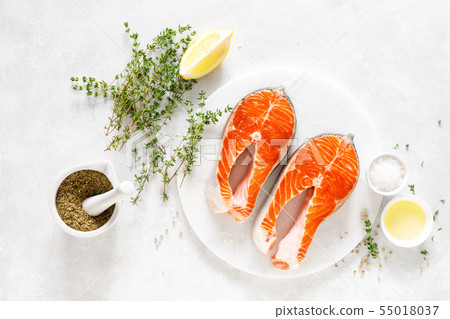 Fresh salmon steaks with ingredients for cooking Fresh salmon steaks with ingredients for cooking 55018037