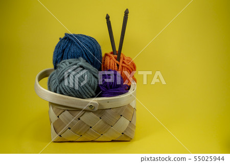 Knitting yarn balls and needles in basket Knitting yarn balls and needles in basket 55025944