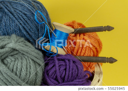 Knitting yarn balls and needles in basket Knitting yarn balls and needles in basket 55025945