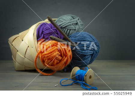 Knitting yarn balls and needles in basket 55025949