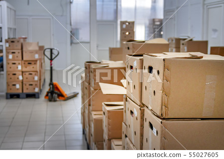 Cardboard boxes in a large warehouse Cardboard boxes in a large warehouse 55027605