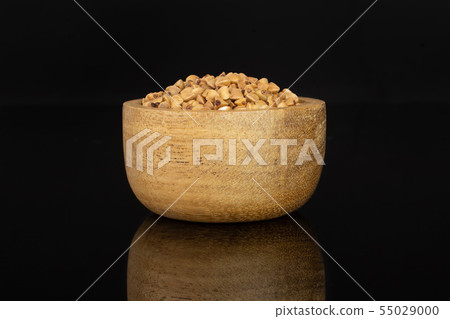 Raw buckwheat grain isolated on black glass 55029000