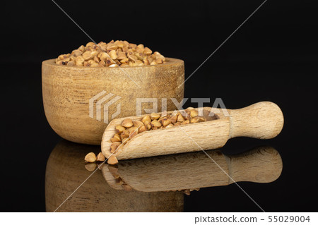 Raw buckwheat grain isolated on black glass Raw buckwheat grain isolated on black glass 55029004