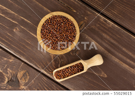 Red quinoa seeds on brown wood Red quinoa seeds on brown wood 55029015