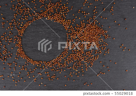 Red quinoa seeds on grey stone Red quinoa seeds on grey stone 55029018