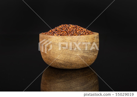 Red quinoa seeds isolated on black glass Red quinoa seeds isolated on black glass 55029019