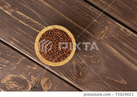 Red quinoa seeds on brown wood Red quinoa seeds on brown wood 55029021