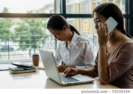Business adviser analyzing financial figures Business adviser analyzing financial figures 55030594
