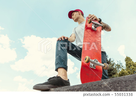 Skateboarder at the city's street in sunny day Skateboarder at the city's street in sunny day 55031338
