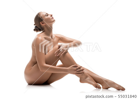 Naked girl sitting on the floor view Naked girl sitting on the floor view 55031840