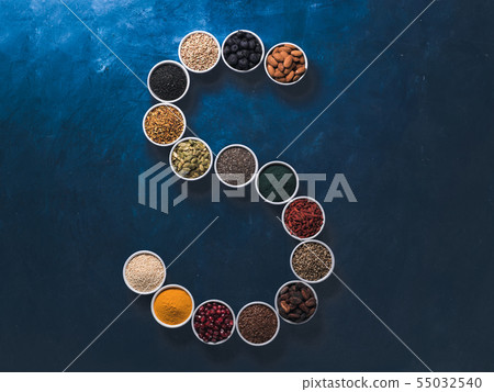 S letter of superfoods in bowl on blue background 55032540