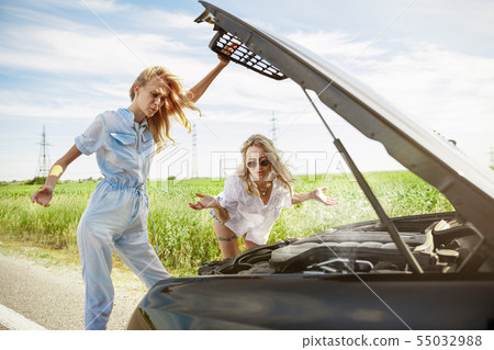 Young lesbian's couple going to vacation trip on the car in sunny day 55032988