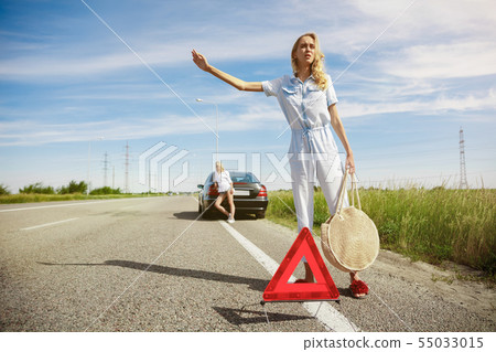 Young lesbian's couple going to vacation trip on the car in sunny day Young lesbian's couple going to vacation trip on the car in sunny day 55033015
