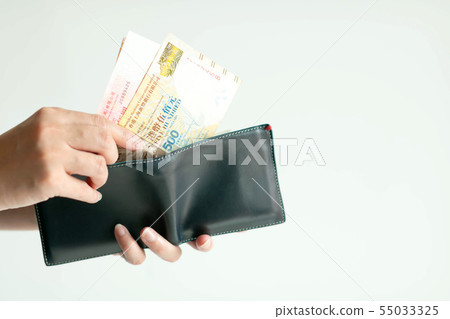 Hands picking Dollars Hong Kong (HKD) from wallet. Hands picking Dollars Hong Kong (HKD) from wallet. 55033325