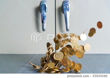 Falling gold coins money on office table with Falling gold coins money on office table with 55034380