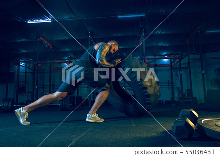 Young healthy man athlete doing exercise in the gym Young healthy man athlete doing exercise in the gym 55036431