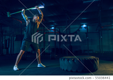 Young healthy man athlete doing exercise in the gym Young healthy man athlete doing exercise in the gym 55036441