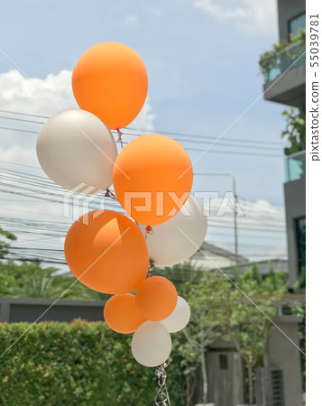 Group of orange and white balloons Group of orange and white balloons 55039781
