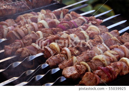 Kebabs on skewers prepared on charcoal grill Kebabs on skewers prepared on charcoal grill 55039925