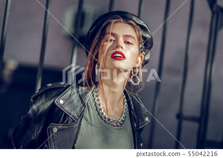 Stunning languid woman in leather outfit having red lips 55042216