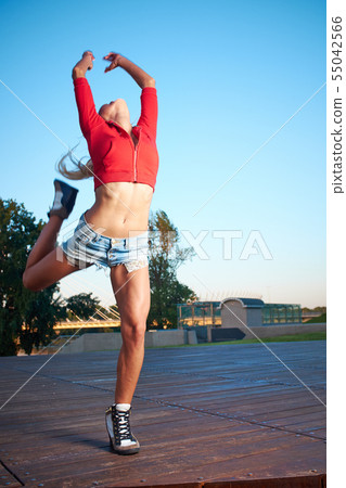 Athlete celebrating jumping and leaping against a Athlete celebrating jumping and leaping against a 55042566