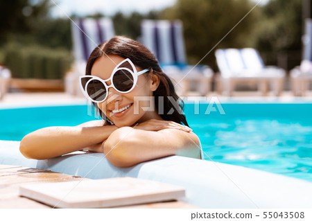 Woman feeling amazing spending weekend near pool Woman feeling amazing spending weekend near pool 55043508