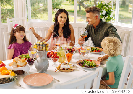 Children eating salads for lunch with their parents 55044200