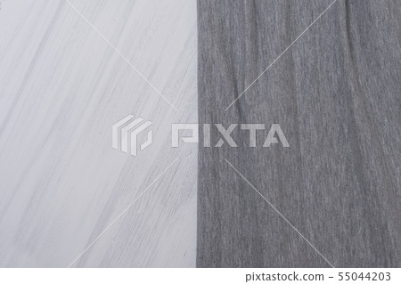 Part of the gray fabric on a light wooden Part of the gray fabric on a light wooden 55044203