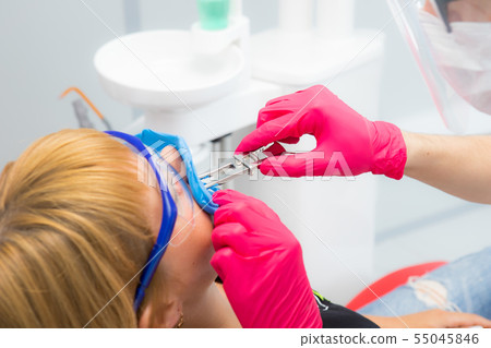 the dentist prepares the patient for treatment 55045846