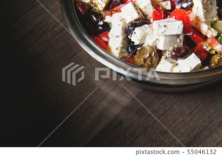 Close-up of delicious gourmet tomato and olives feta cheese salad sprinkled with spices of herbs 55046132
